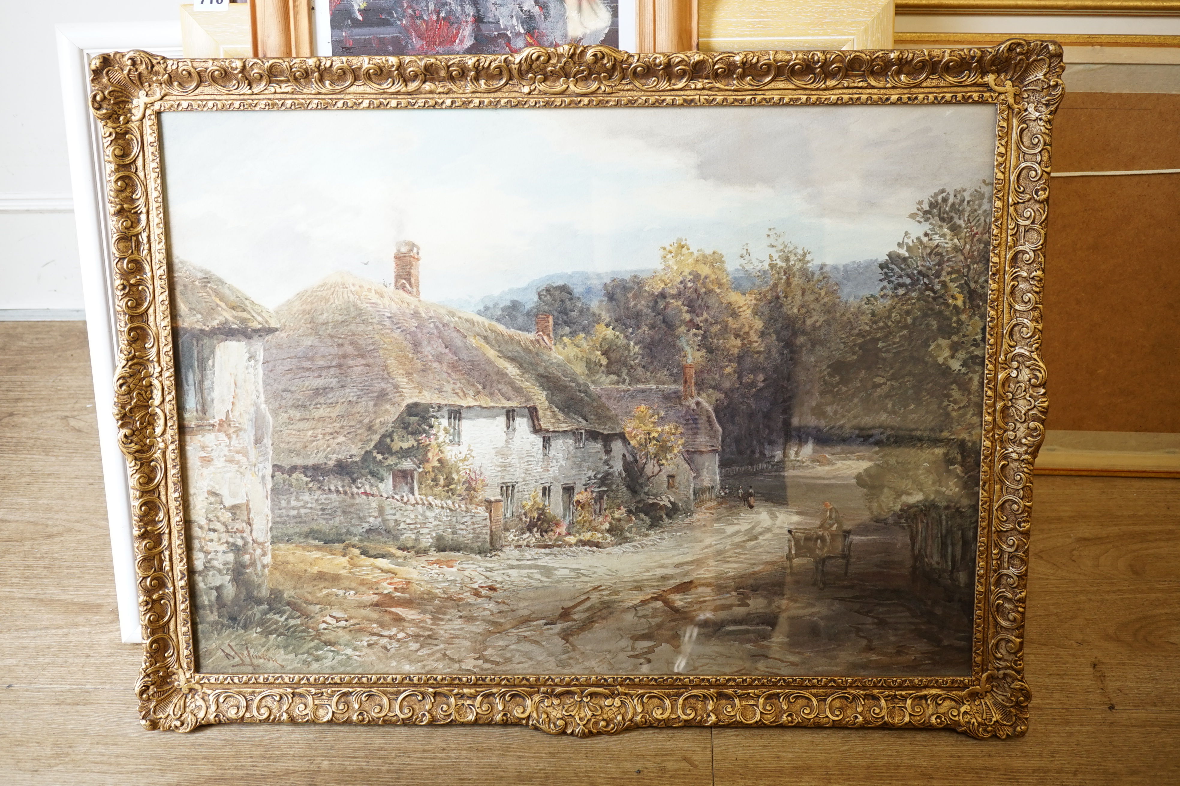 Alfred Leymann (1856-1933), watercolour, Horse and cart passing thatched cottages, signed, 53 x 74cm